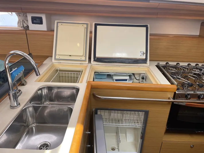 Kindred Spirit Yacht Photos Pics Galley of 2008 Jeanneau Sun Odyssey 45 DS with sink, stove, and storage compartments.