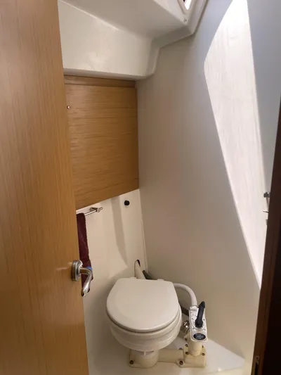 Kindred Spirit Yacht Photos Pics 2008 Jeanneau Sun Odyssey 45 DS yacht bathroom with compact toilet and wooden accents.