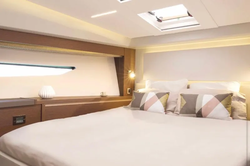  Yacht Photos Pics Luxurious bedroom interior of 2018 Prestige 520 yacht with modern decor and soft lighting.