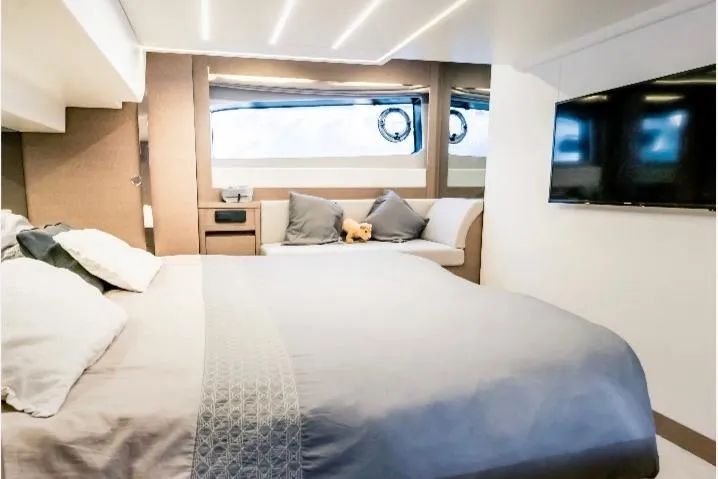 Yacht Photos Pics Luxurious bedroom interior of 2018 Prestige 520 yacht with modern decor and large window.
