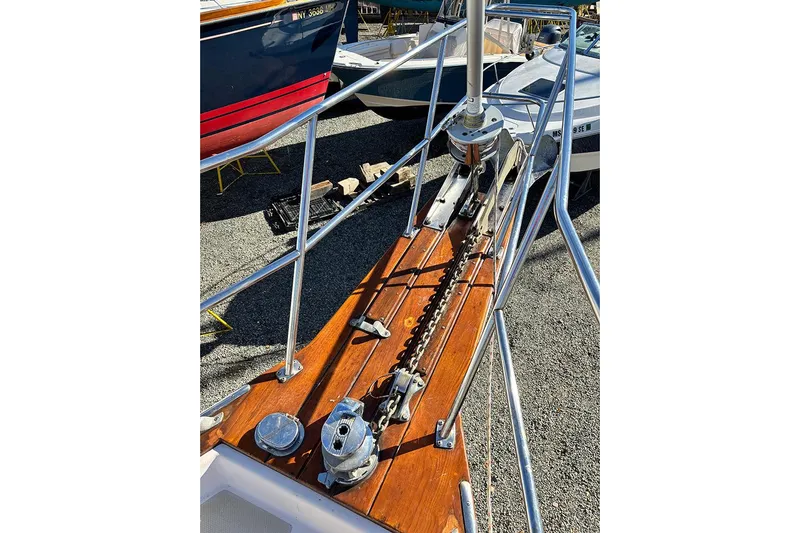 Butternut Yacht Photos Pics Bow of a 1995 Island Packet 37 sailboat with anchor chain and polished wood deck.