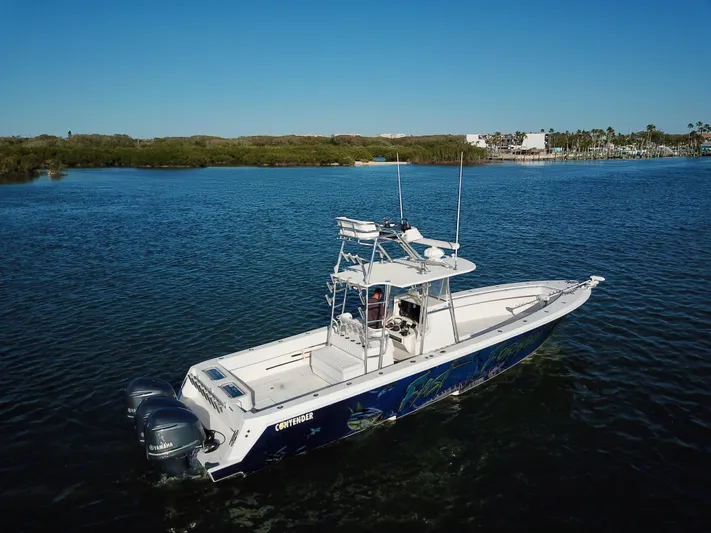 Fast Forward Yacht Photos Pics 2010 Contender 39 ST boat on calm water with clear blue sky.