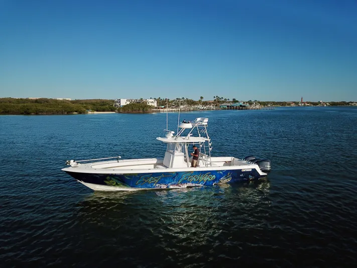 Fast Forward Yacht Photos Pics 2010 Contender 39 ST boat on calm water under clear blue sky.