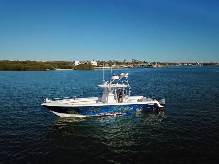 Fast Forward Yacht Photos Pics 2010 Contender 39 ST boat on calm water with scenic background.