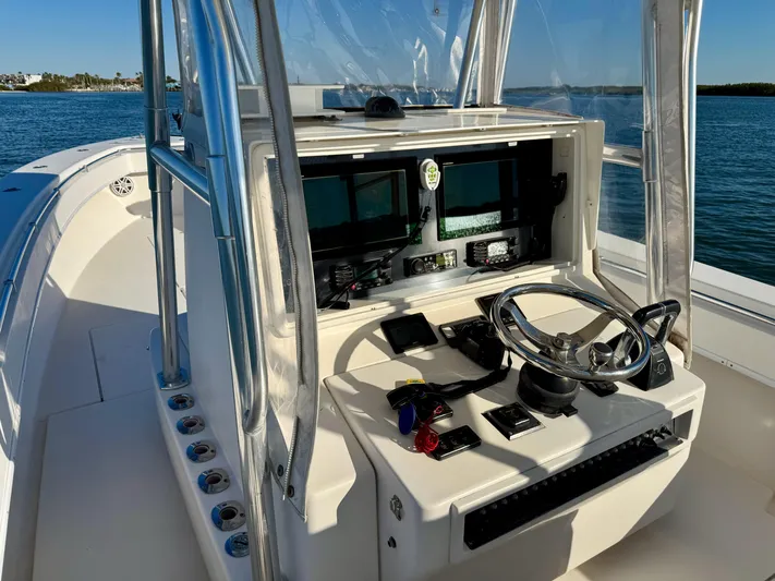 Fast Forward Yacht Photos Pics 2010 Contender 39 ST boat console with steering wheel and navigation screens.