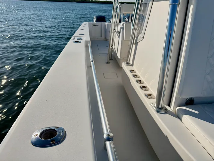 Fast Forward Yacht Photos Pics 2010 Contender 39 ST boat deck with rod holders, on calm water.