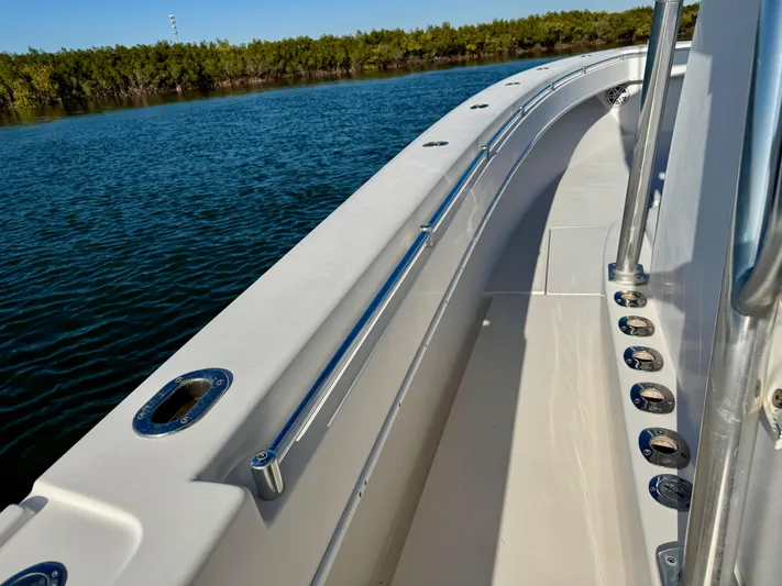 Fast Forward Yacht Photos Pics 2010 Contender 39 ST boat deck with stainless steel railings on calm water.