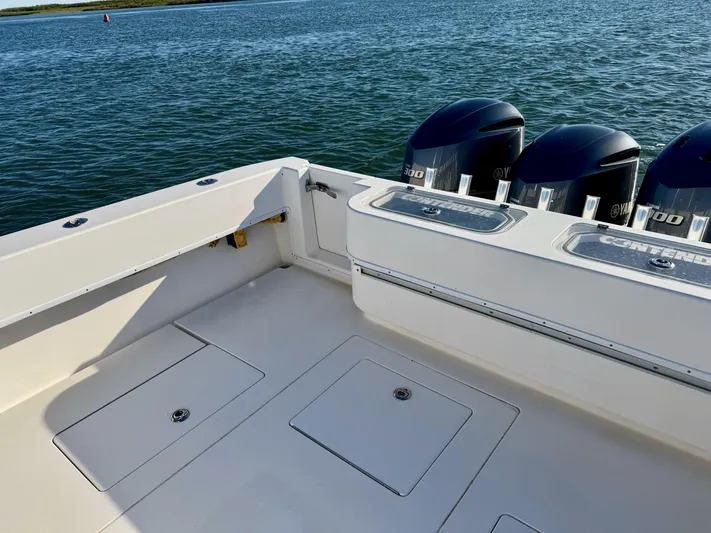 Fast Forward Yacht Photos Pics 2010 Contender 39 ST boat with triple outboard engines on calm water.