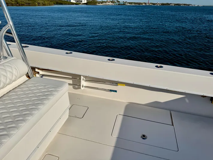 Fast Forward Yacht Photos Pics 2010 Contender 39 ST boat deck with seating, overlooking calm blue waters.