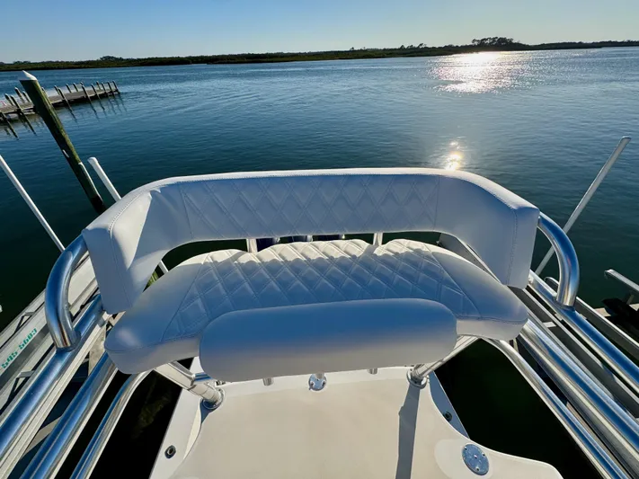 Fast Forward Yacht Photos Pics Contender 39 ST 2010 boat with white cushioned seating, overlooking calm water.