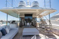 Luxurious 2016 Custom Line Navetta 28 yacht deck with seating, dining area, and staircase.