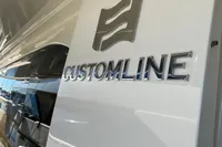 Custom Line Navetta 28 yacht, 2016 model, sleek white exterior with logo detail.