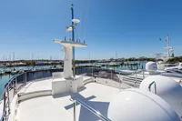 Luxurious 2016 Custom Line Navetta 28 yacht deck with marina view under clear blue sky.