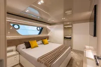 Luxurious bedroom interior on 2016 Custom Line Navetta 28 yacht with modern design and large window.