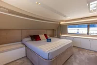 Luxurious bedroom interior of 2016 Custom Line Navetta 28 yacht with modern design and large window.