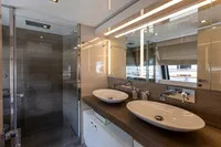 Luxurious bathroom in 2016 Custom Line Navetta 28 yacht with dual sinks and modern shower.