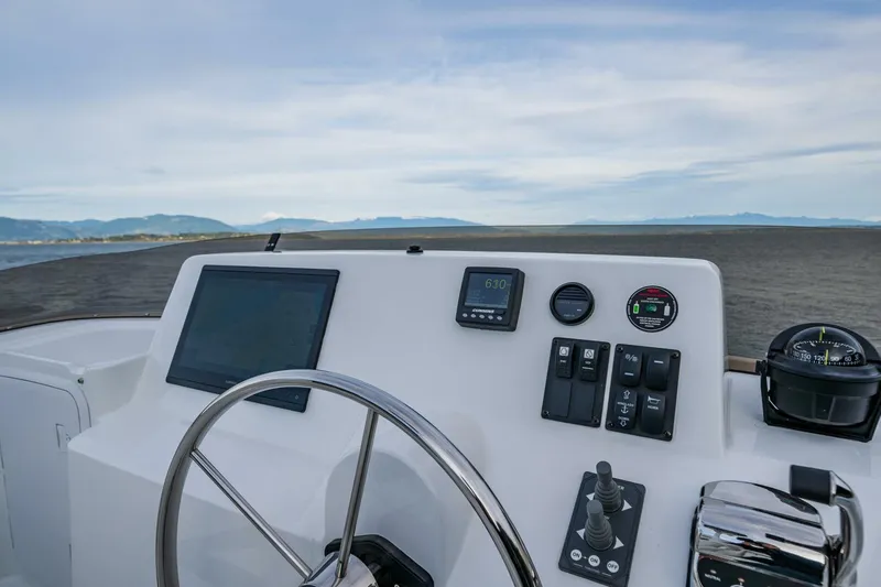 New Boat Hull #12 Yacht Photos Pics Nordic Tug 40 helm with navigation controls and sea view, 2024 model.