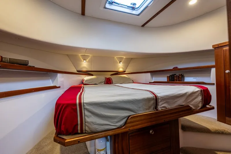 New Boat Hull #12 Yacht Photos Pics 2024 Nordic Tug 40 cabin interior with cozy bed and wooden accents.