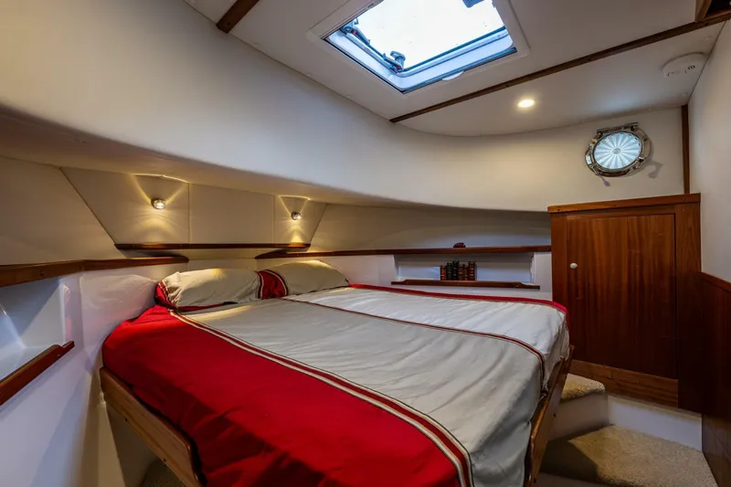 New Boat Hull #12 Yacht Photos Pics 2024 Nordic Tug 40 cabin with skylight, cozy bed, and wooden accents.