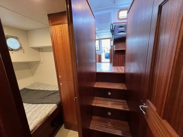 New Boat Hull #12 Yacht Photos Pics Interior of 2024 Nordic Tug 40, featuring wooden stairs and cozy cabin space.