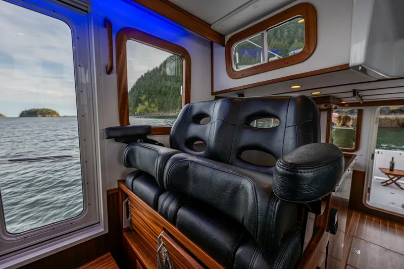 New Boat Hull #12 Yacht Photos Pics Luxurious interior of 2024 Nordic Tug 40 with leather seating and scenic water view.