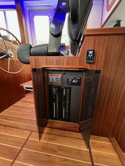 New Boat Hull #12 Yacht Photos Pics 2024 Nordic Tug 40 interior with control panel and wooden finish.