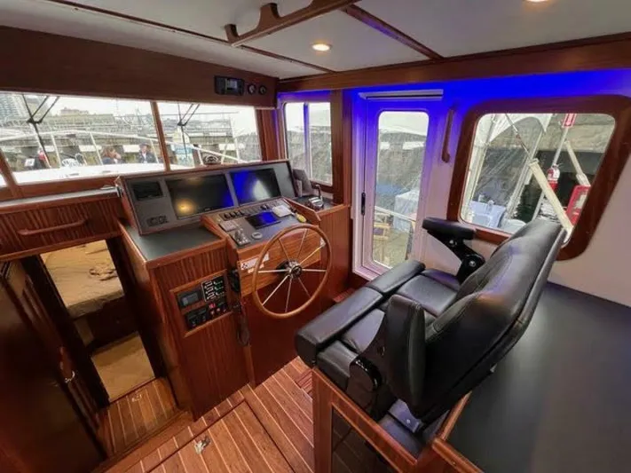 New Boat Hull #12 Yacht Photos Pics 2024 Nordic Tug 40 helm with modern controls and comfortable seating.