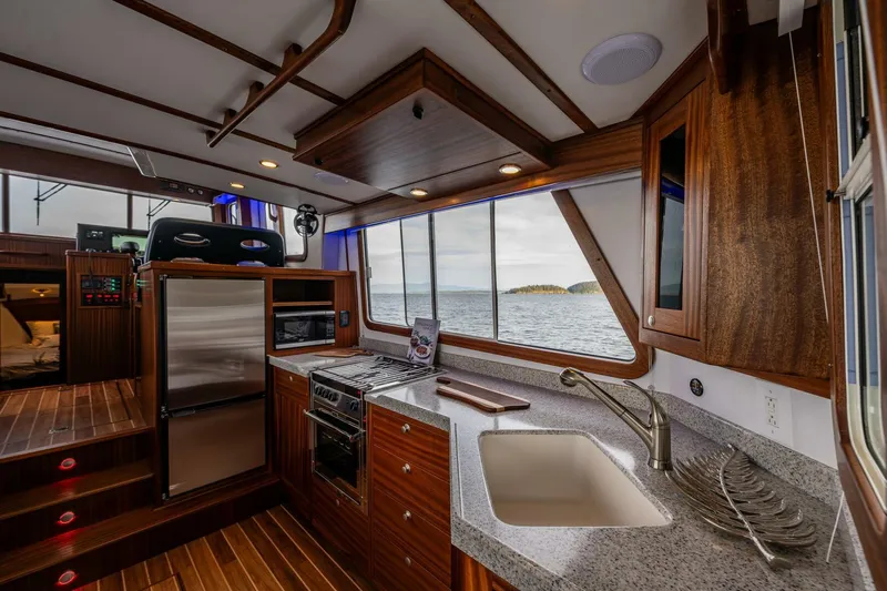 New Boat Hull #12 Yacht Photos Pics 2024 Nordic Tug 40 interior with modern kitchen and ocean view.