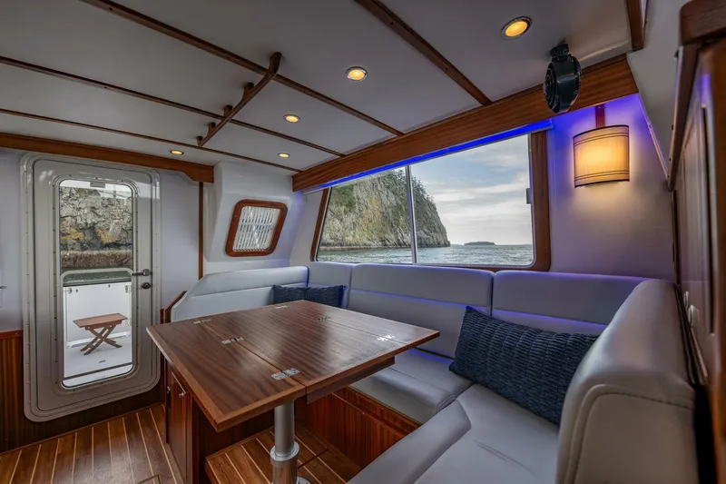New Boat Hull #12 Yacht Photos Pics Luxurious interior of 2024 Nordic Tug 40 with ocean view and elegant seating area.