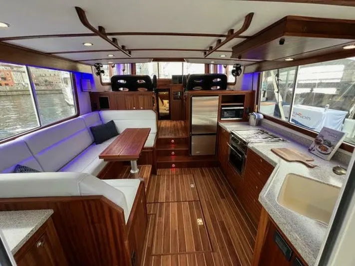 New Boat Hull #12 Yacht Photos Pics Luxurious interior of 2024 Nordic Tug 40 with modern kitchen and seating area.