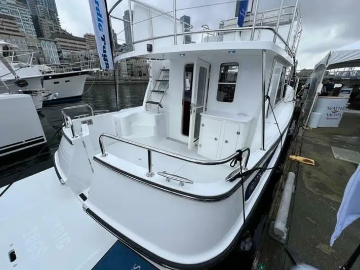 New Boat Hull #12 Yacht Photos Pics 2024 Nordic Tug 40 docked at marina, showcasing spacious deck and modern design.