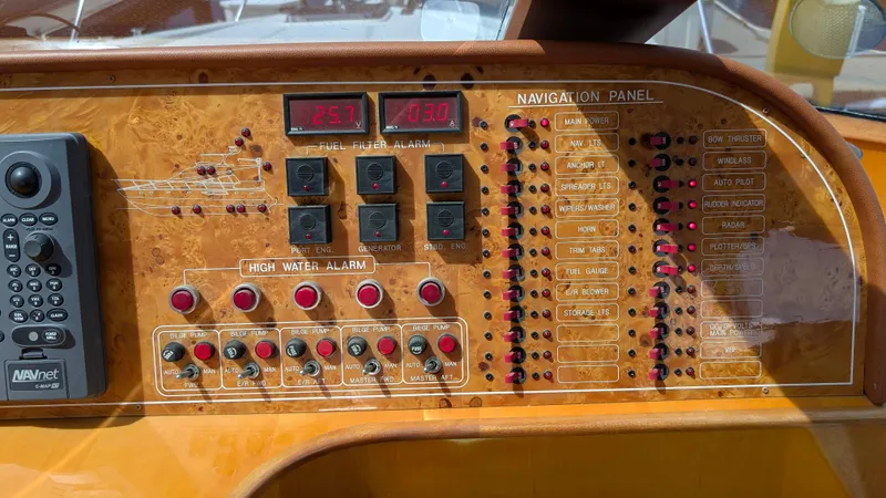 Odeesea Yacht Photos Pics Control panel of a 2004 Johnson Motor Yacht, featuring navigation and alarm systems.