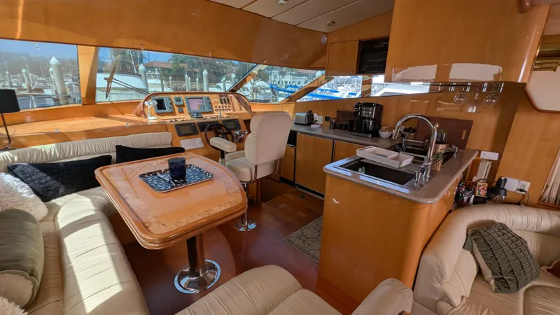 Odeesea Yacht Photos Pics Luxurious 2004 Johnson Motor Yacht interior with plush seating and modern kitchen amenities.