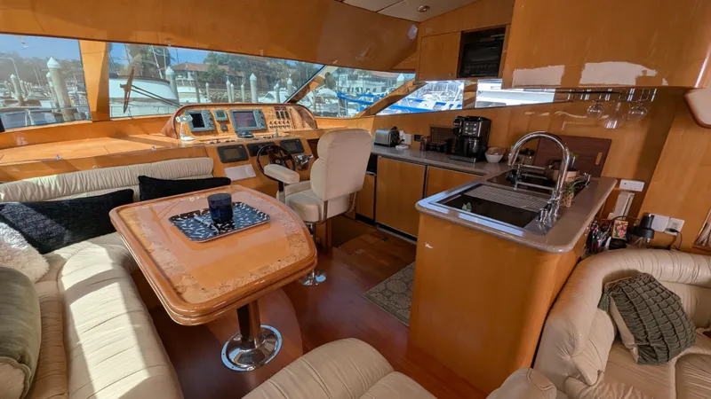 Odeesea Yacht Photos Pics Luxurious 2004 Johnson Motor Yacht interior with helm, kitchen, and seating area.