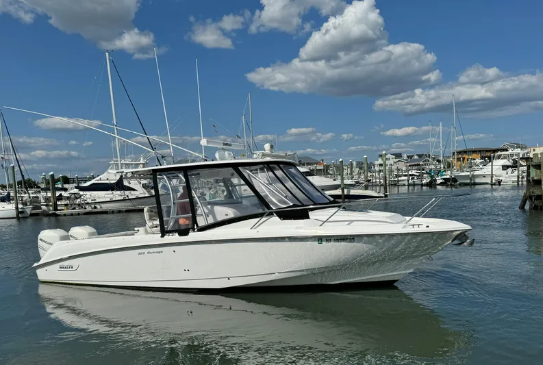 No Name Yacht Photos Pics 2006 Boston Whaler 32 Outrage Cuddy in marina, clear sky, calm water.