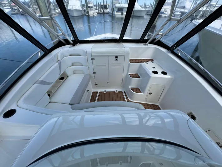 No Name Yacht Photos Pics 2006 Boston Whaler 32 Outrage Cuddy interior with seating and wood accents.