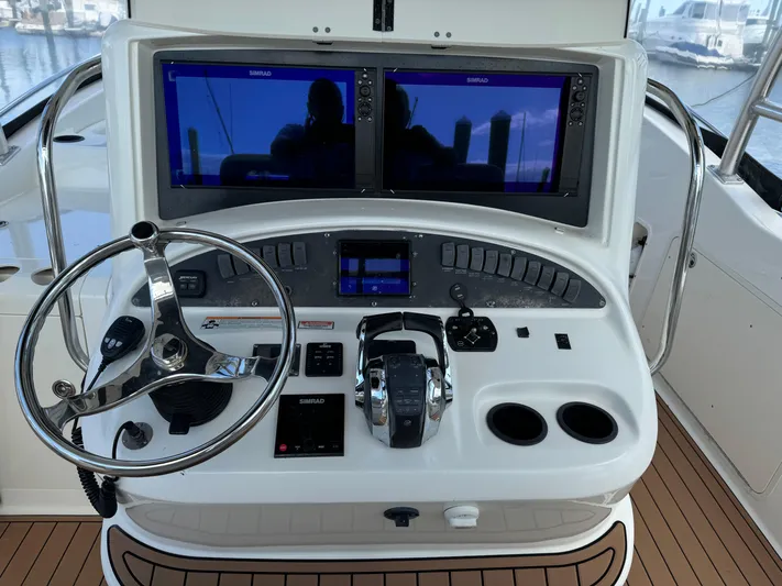 No Name Yacht Photos Pics 2006 Boston Whaler 32 Outrage Cuddy helm with dual Simrad displays and steering wheel.