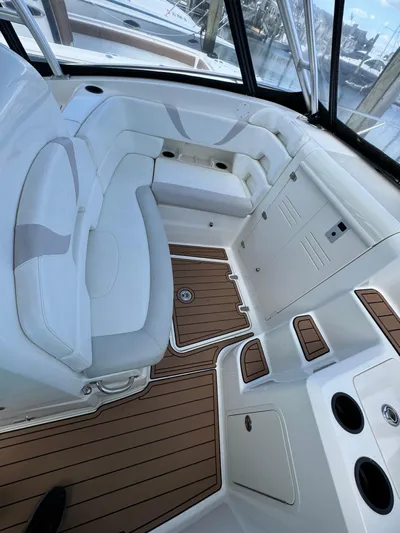 No Name Yacht Photos Pics 2006 Boston Whaler 32 Outrage Cuddy interior with cushioned seating and wood-style flooring.