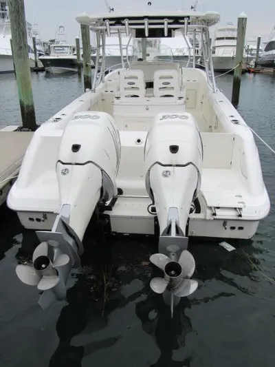 No Name Yacht Photos Pics 2006 Boston Whaler 32 Outrage Cuddy with twin engines docked at marina.