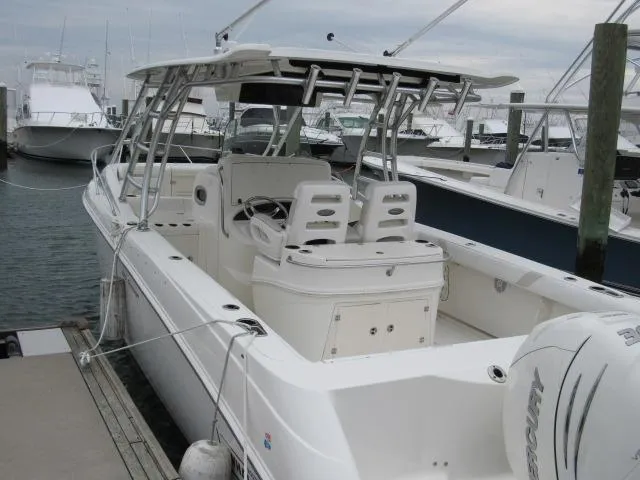No Name Yacht Photos Pics 2006 Boston Whaler 32 Outrage Cuddy docked at marina, featuring spacious deck and seating.