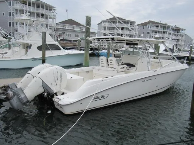 No Name Yacht Photos Pics 2006 Boston Whaler 32 Outrage Cuddy docked in marina, surrounded by other boats.
