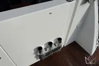 2017 Beneteau Swift Trawler 30 deck with rod holders and wooden flooring.