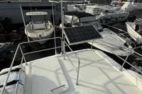 2017 Beneteau Swift Trawler 30 on deck, featuring solar panel and marina view.