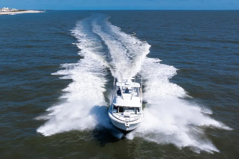 One More Yacht Photos Pics 2018 Bertram 35 Flybridge Sportfish cruising swiftly on open water.