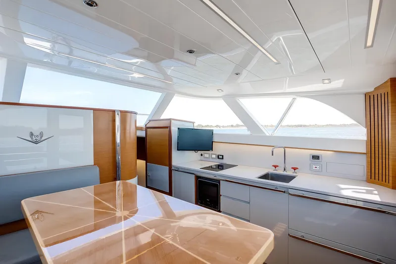 One More Yacht Photos Pics Luxurious interior of 2018 Bertram 35 Flybridge Sportfish yacht with modern kitchen and dining area.