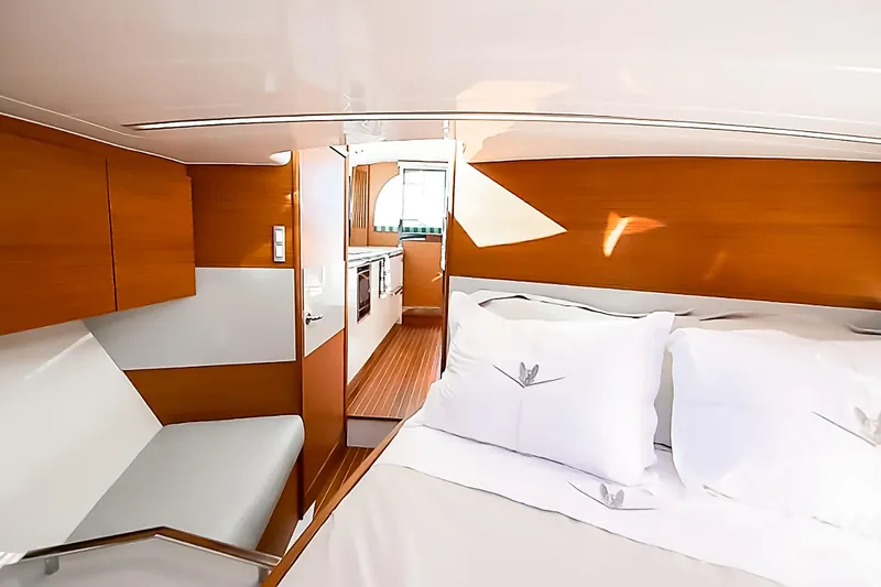 One More Yacht Photos Pics Interior of 2018 Bertram 35 Flybridge Sportfish, featuring cozy cabin with bed and seating.