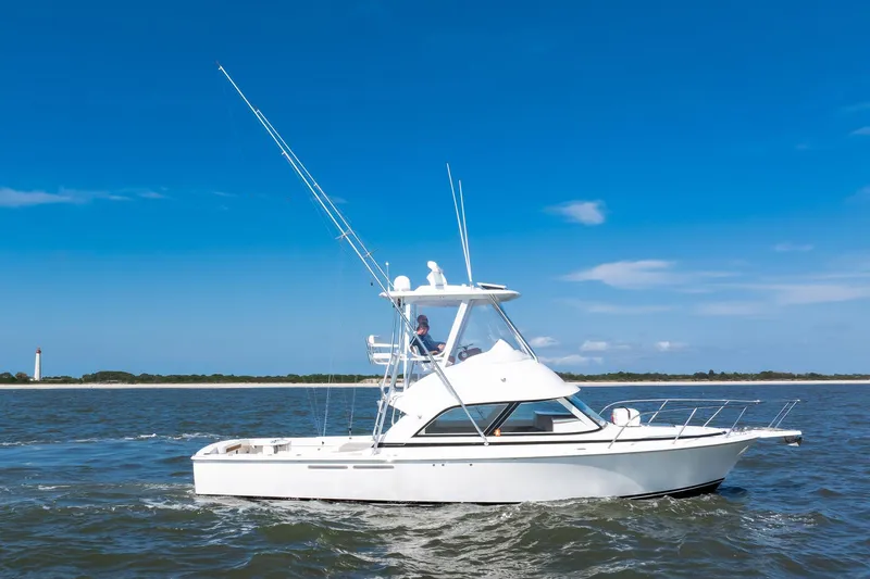 One More Yacht Photos Pics 2018 Bertram 35 Flybridge Sportfish cruising on open water under clear blue sky.