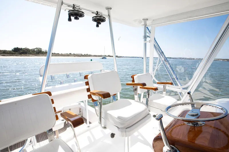 One More Yacht Photos Pics 2018 Bertram 35 Flybridge Sportfish interior with ocean view, featuring white seating and wooden accents.