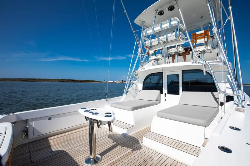One More Yacht Photos Pics 2018 Bertram 35 Flybridge Sportfish yacht with spacious deck and seating, cruising on calm waters.