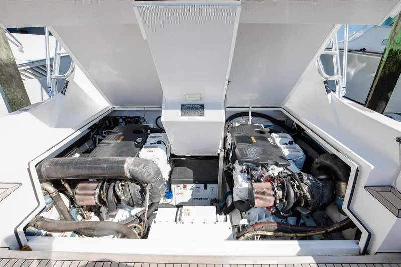 One More Yacht Photos Pics Engine compartment of 2018 Bertram 35 Flybridge Sportfish, showcasing dual engines.